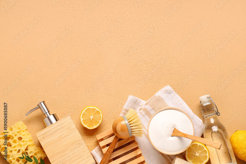 Fototapeta premium Baking soda with vinegar, lemons and cleaning supplies on orange grunge background