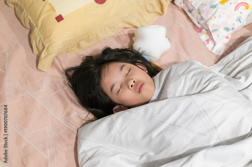 Obraz premium Young Asian Girl Sound Asleep in Bed