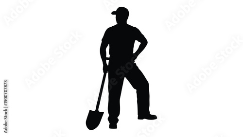 Silhouette of a worker with a shovel standing with hands on hips