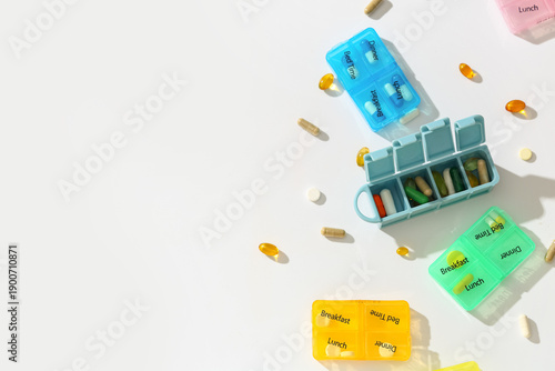 Container with pills on whi...