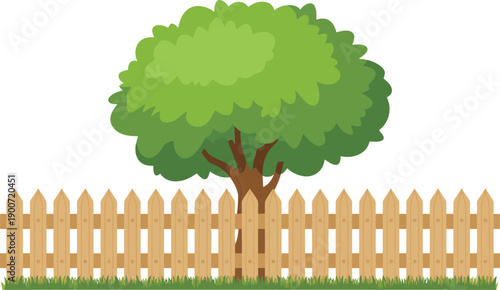A large green tree is placed behind a brightly colored wooden picket fence and green grass
