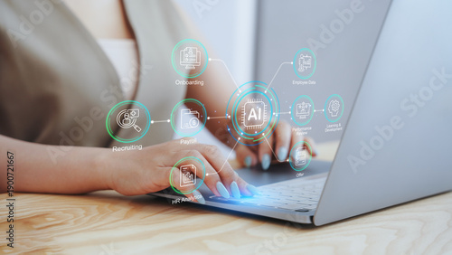 Businesswoman using laptop with virtual AI human resources dashboard and workflow icons. Concept of HR automation, smart recruiting strategy, digital employee management, and workforce analytics.