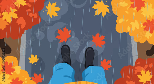 Rain falling on autumn leaves and feet wearing boots