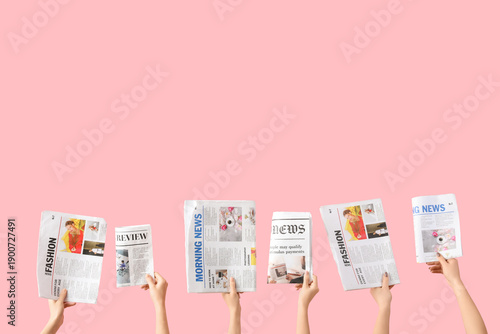 Women with newspapers on pi...
