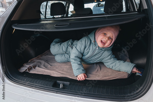 A child in winter clothes screams in the trunk of a car. Kidnapping, crime.