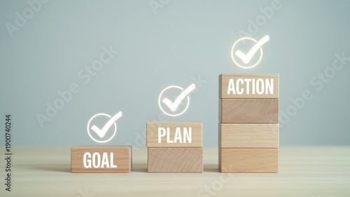 Business strategy steps with goal plan and action on wooden blocks