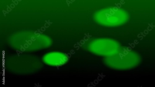 Abstract green glowing circles with blurred, luminous effect against dark background