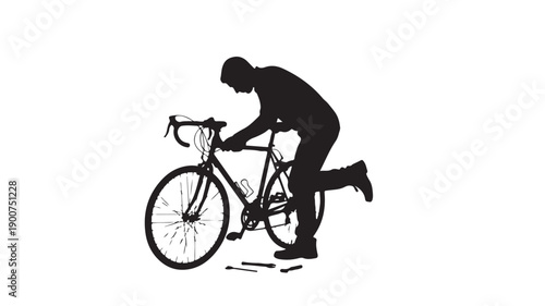 Silhouette of a cyclist riding a bicycle with one knee on the ground.