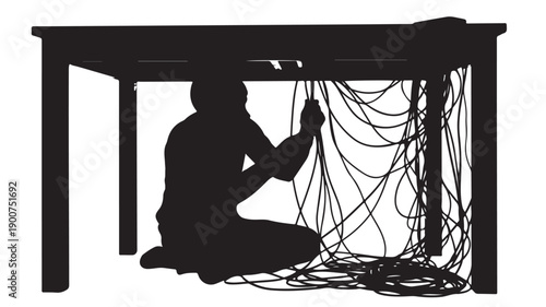 Man Sitting Under Table with Entangled Cables and Wires.