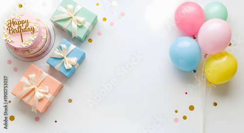 Celebration scene with cake, gifts, and balloons on a table, viewed from above