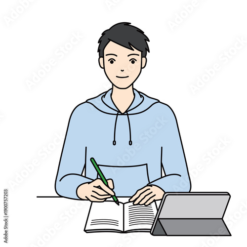 High school boy in hoodie studying with notebook and tablet