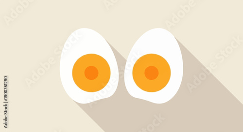 Two halved hard-boiled eggs with bright orange yolks sit on a light background