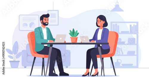 Two professionals collaborate at a table with laptops in a modern office