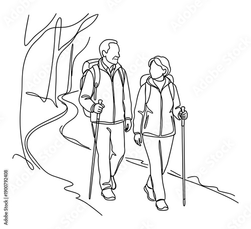 Elderly couple hiking in forest with sticks