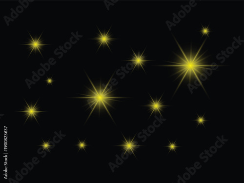 A collection of bright golden starbursts and sparkling points of light against a dark black background