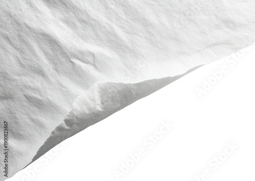 Close-up of crumpled white fabric against a stark black background, showcasing texture