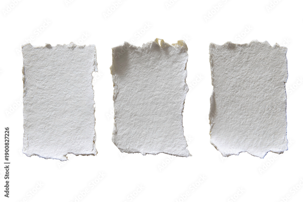 Obraz premium Three rectangular, deckled-edge white paper scraps against a stark black background