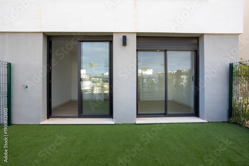 Ground floor apartment with sliding glass doors and private artificial grass garden