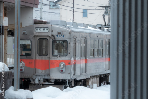 Local Commuter Train Stopped in Snowy Japanese Town