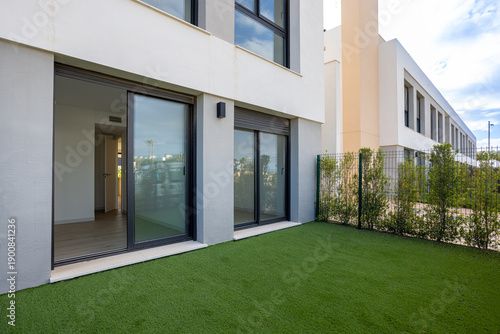 Modern apartment with private artificial lawn and dual sliding glass doors