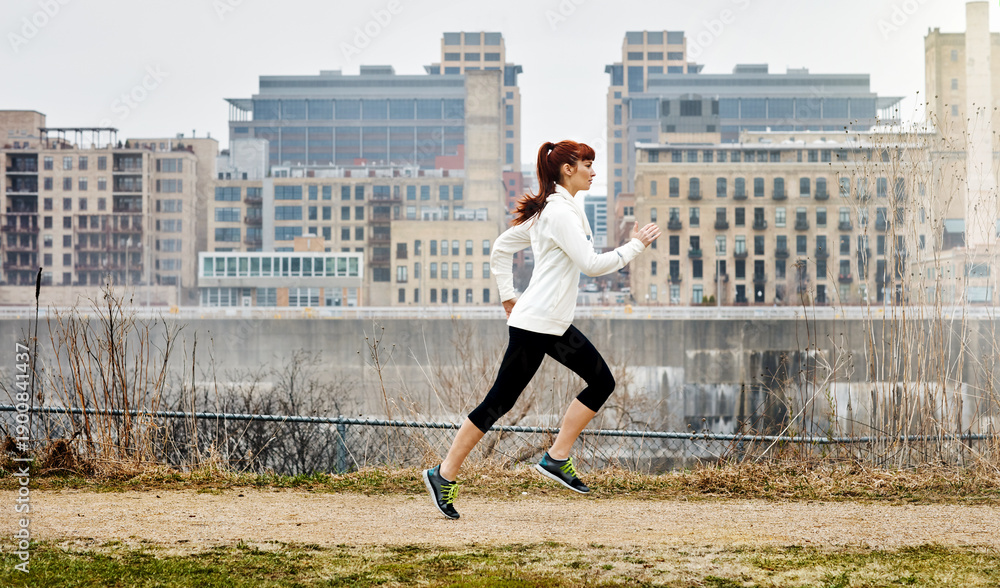 Naklejka premium Athlete, woman and running for fitness outdoor for exercise, cardio training and morning routine. Female person, runner and sprint for challenge, endurance workout and performance of wellness in city