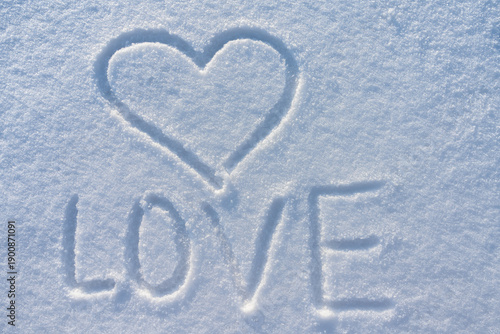Word Love and Heart Written in Snow.