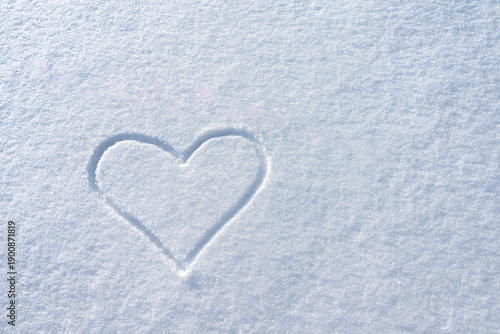 Word Love and Heart Written in Snow.