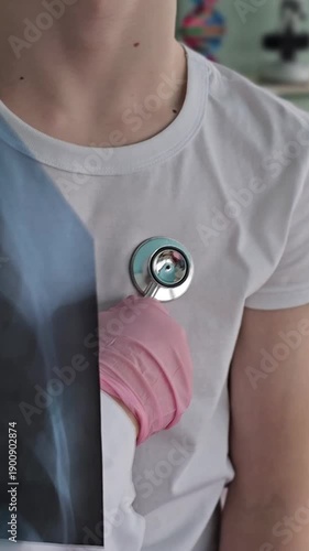 Wallpaper Mural Doctor examines patient with stethoscope while looking at chest X-ray in a medical office Torontodigital.ca