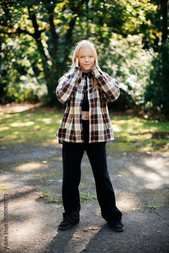 Teenage Girl Standing in Park Wearing Plaid Jacket Casual Outfit