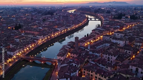 Wallpaper Mural The sunset casts a warm glow over the river, enhancing the beauty of the city. Buildings line the riverbanks, with lights reflecting in the water as the sky transitions. Torontodigital.ca