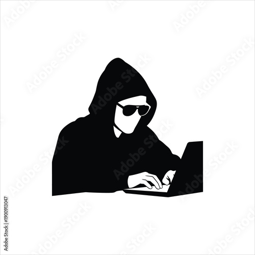 Silhouette of a hooded figure using a laptop suggesting anonymity