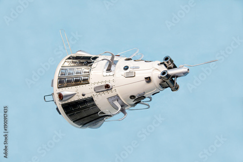 An artificial earth satellite mock-up isolated on a light background. Space, near-Earth spacecraft, technology, science.