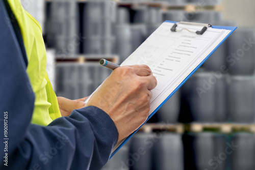 Hands, engineer and clipboard for checklist, inspection notes or control of barrels of oil. Person,writing with documents for, project management or supervisor paperwork and pen