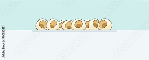 A row of halved boiled eggs on a blue and white background