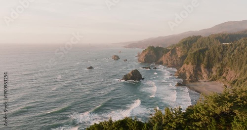 Aerial view of the Oregon coastline where the rough sea meets the steep cliffs, Brookings, Oregon, United States.