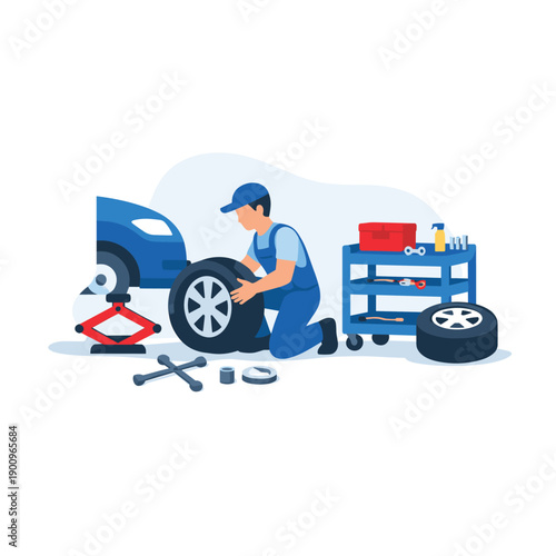 Mechanic changing tire in automotive workshop