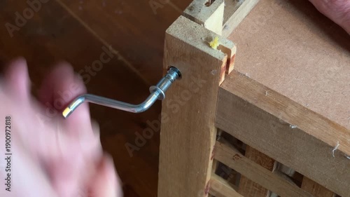 Unsrewing taking apart a flat-pack table