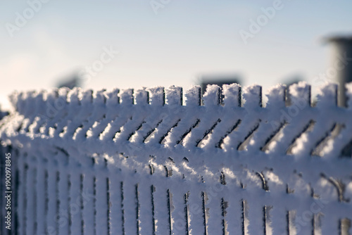 snowy fence with blue sky