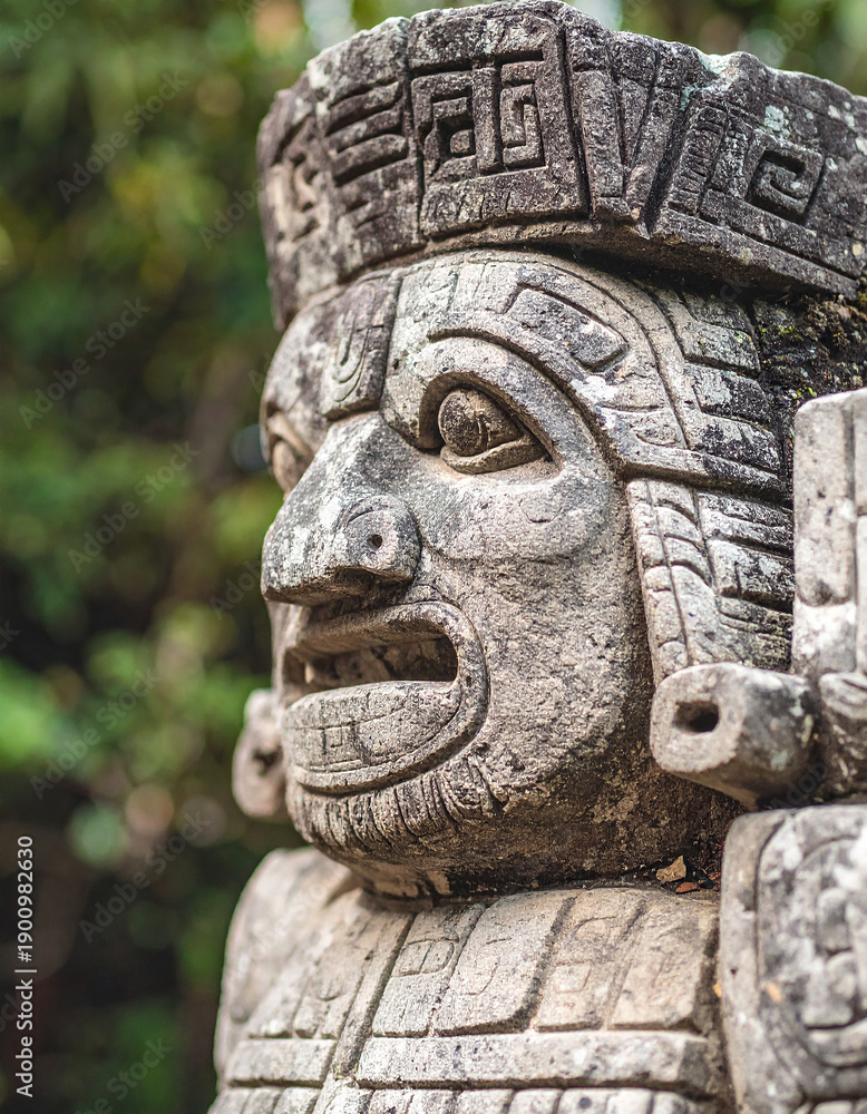 Obraz premium Ancient Mayan or Aztec stone god statue, detailed carved textures, outdoor natural environment