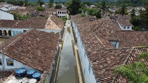 Aerial shot following a flooded street in Paraty, Brazil, made to cleanse the town in colonial times. Flooding occurs at high tide during full and new moon, blending history with unique visuals