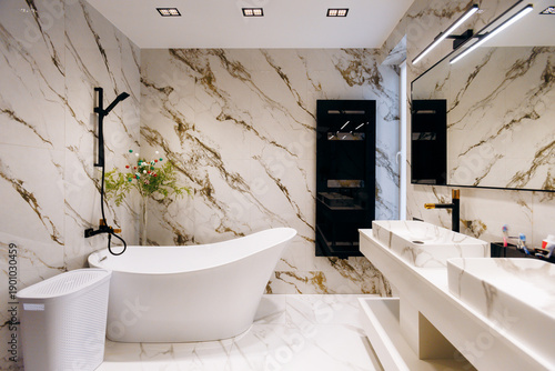 Obraz na plátně Elegant freestanding tub near marble wall with calming ambiance