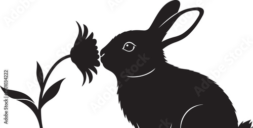 A black silhouette of a rabbit smelling a flower