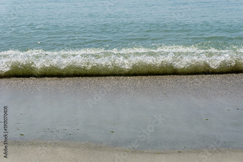 Sand and sea with waves on the beach