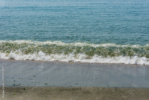 Sand and sea with waves on the beach