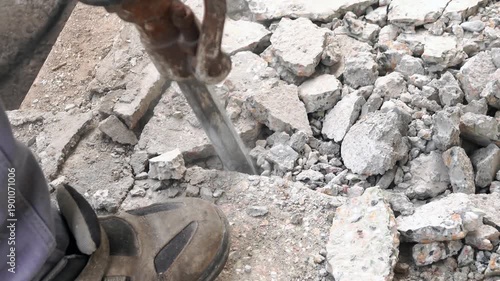 2 Clips: Worker man mason drilling cement concrete floor with jackhammer. Builder worker use rusty demolition tool.