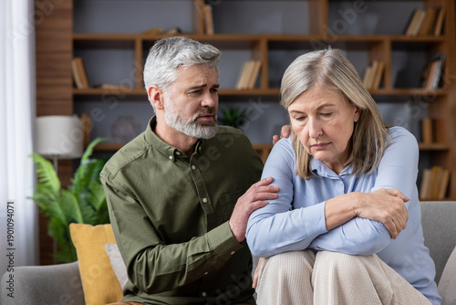 фотографія Senior man offering support and empathy to a distressed older woman, sitting tog