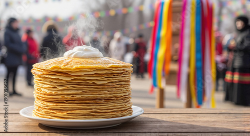 Stack of pancakes with sour cream at Maslenitsa festival outdoors  