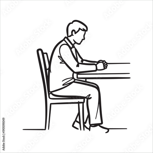 A man sitting at a table with his fists clenched in a contemplative pose