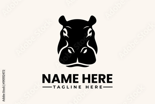 Obraz na plátně A black vector illustration of a hippopotamus head logo with a placeholder name and tagline on a beige background
