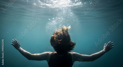 Drowning, Back view of a person sinking underwater